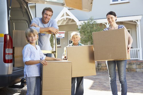 Removal crew handling boxes and furniture with care