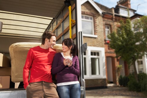 Removal workers estimating volume for a house clearance in Clapham